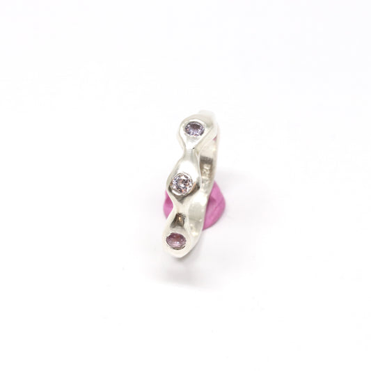 A silver ring with colourful gems. This ring was hand made in Wānaka, New Zealand by designer and jeweller Briar Hardy-Hesson.