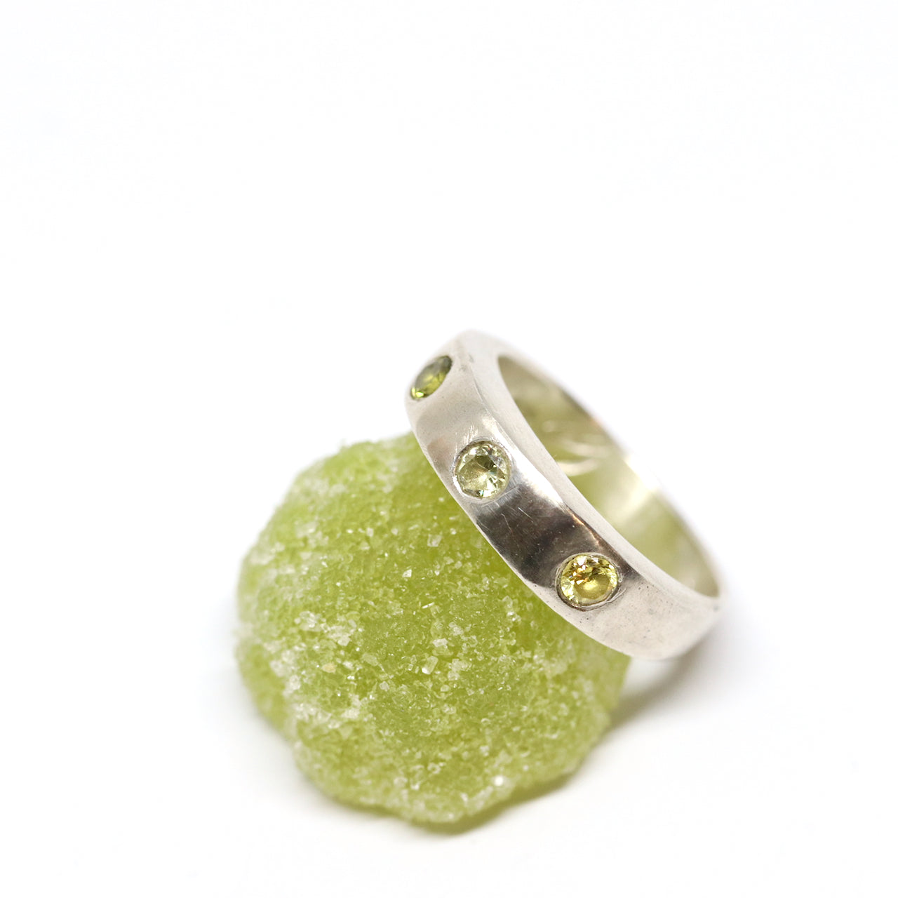 A silver ring with colourful gems. This ring was hand made in Wānaka, New Zealand by designer and jeweller Briar Hardy-Hesson.