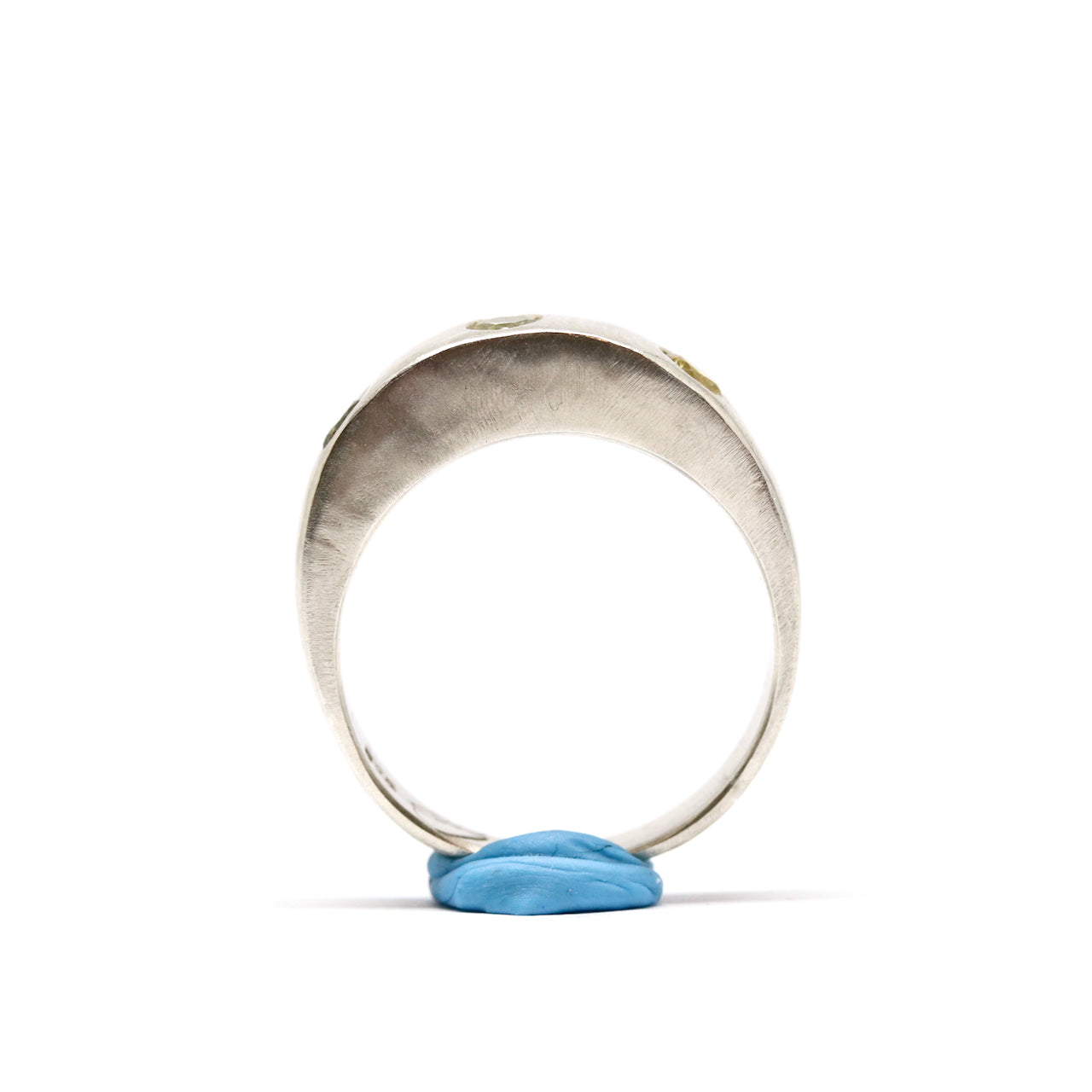 A silver ring with colourful gems. This ring was hand made in Wānaka, New Zealand by designer and jeweller Briar Hardy-Hesson.