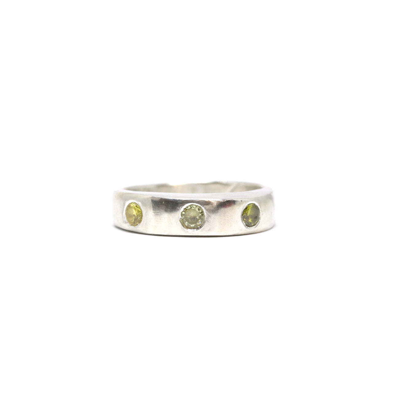 A silver ring with colourful gems. This ring was hand made in Wānaka, New Zealand by designer and jeweller Briar Hardy-Hesson.