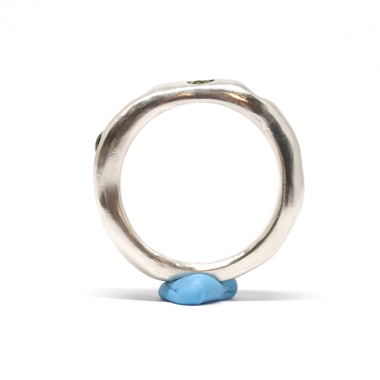 A silver ring with colourful gems. This ring was hand made in Wānaka, New Zealand by designer and jeweller Briar Hardy-Hesson.