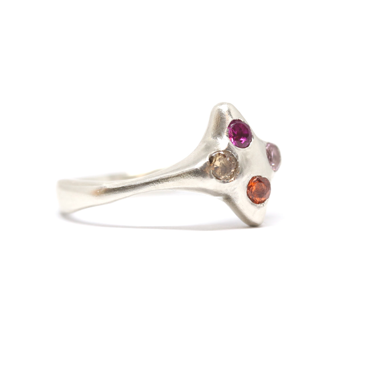 A silver ring with colourful gems. This ring was hand made in Wānaka, New Zealand by designer and jeweller Briar Hardy-Hesson.