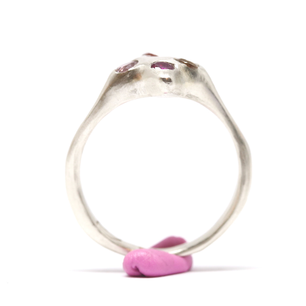 A silver ring with colourful gems. This ring was hand made in Wānaka, New Zealand by designer and jeweller Briar Hardy-Hesson.