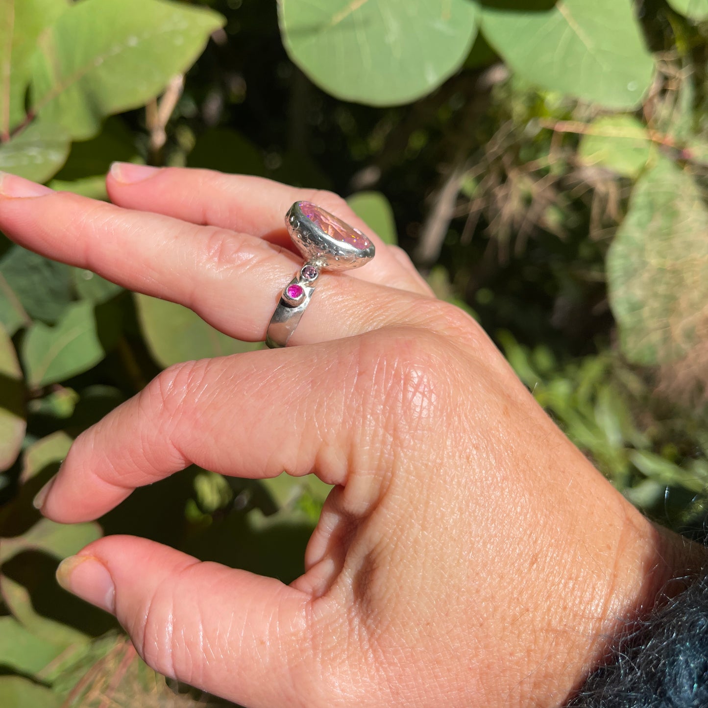 A really big pink cubic zirconia cocktail, statement ring with two ruby pink and two rhodolite cubic zirconia on the shoulders.