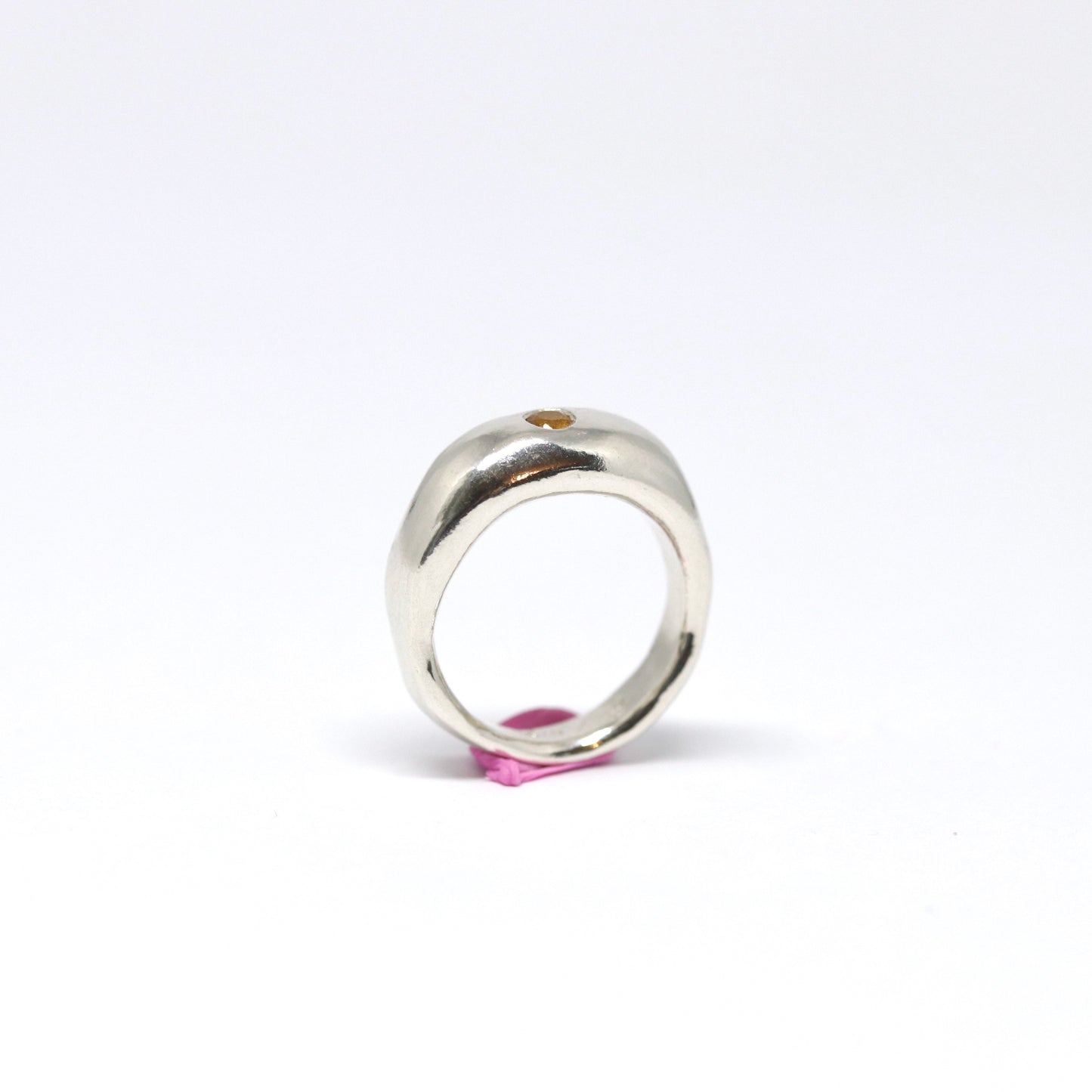A curvy and chunky sterling silver ring with one citrine gem.