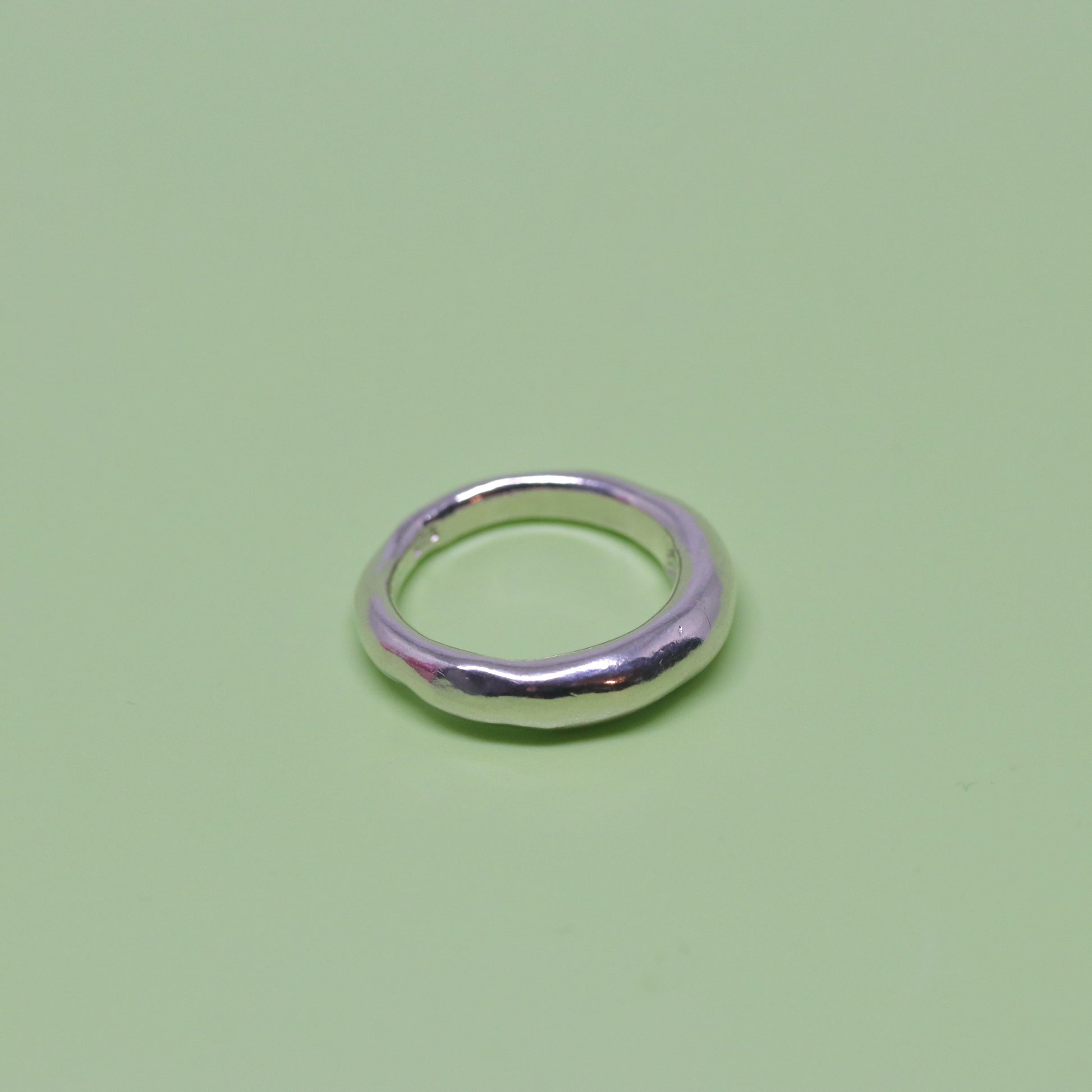 A crescent moon shaped sterling silver ring.