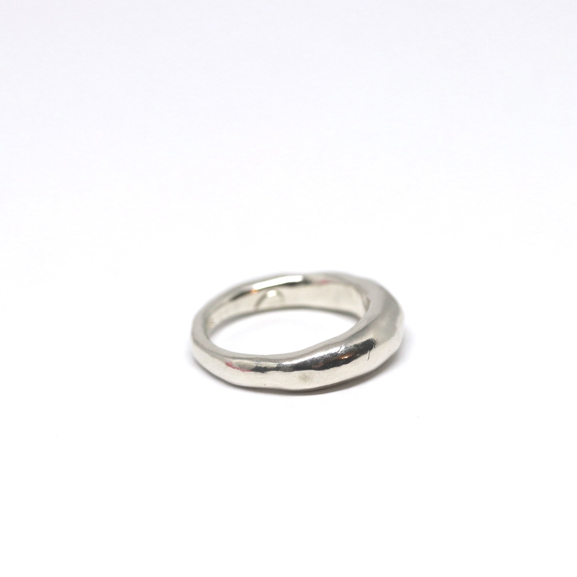 A crescent moon shaped sterling silver ring.