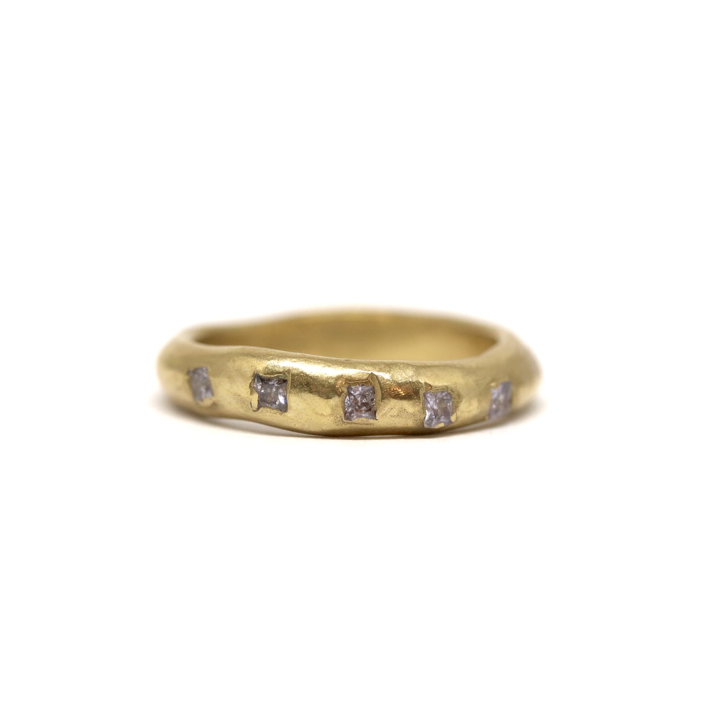 Bronze ring with square lavender gemstones on a white background