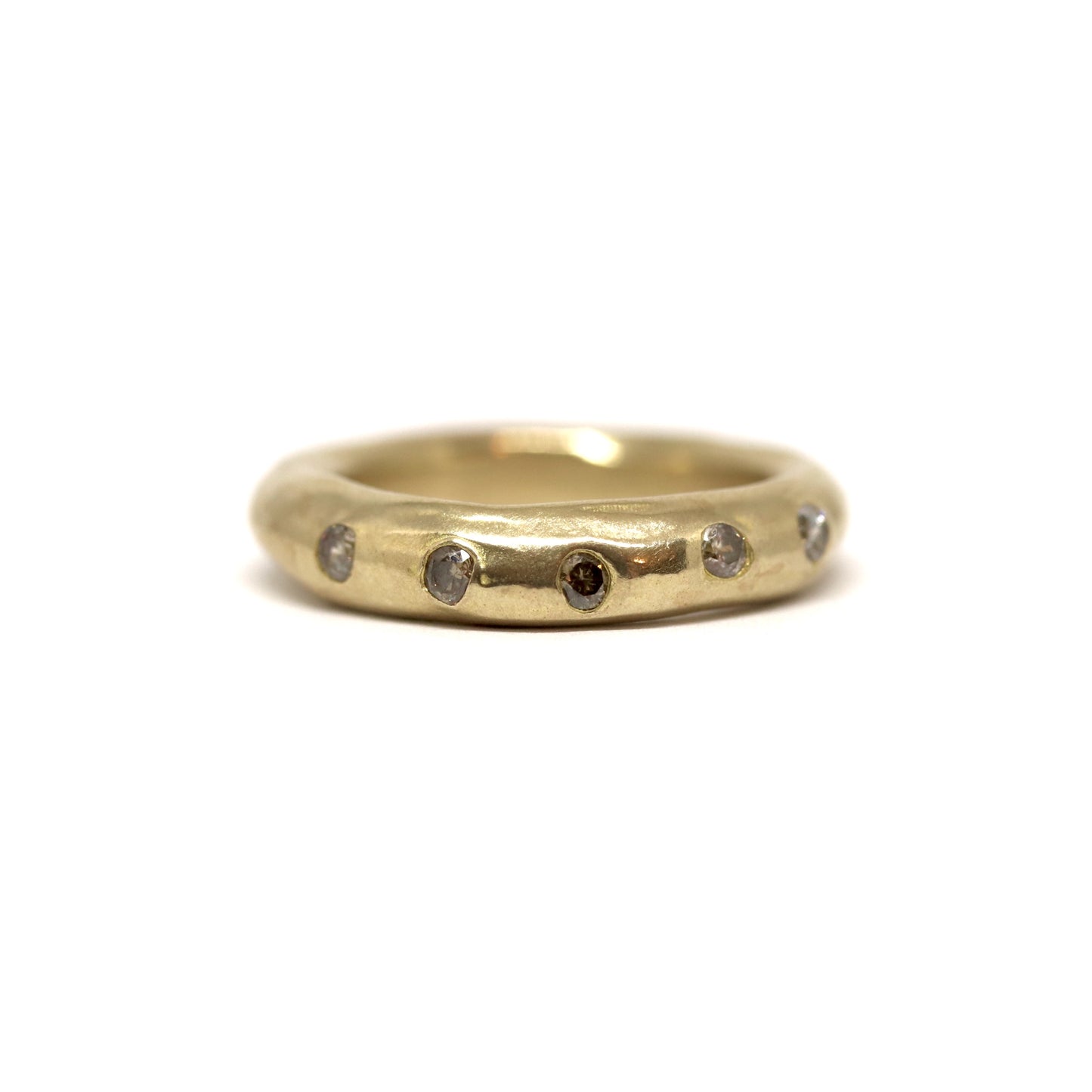 Bronze ring with smoky grey gemstones on a white background