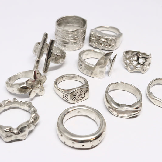 sterling silver rings of various shapes on white background