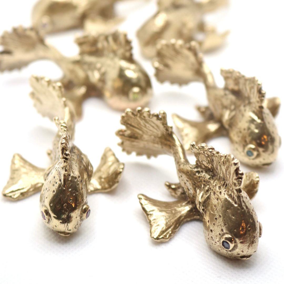 Bronze Gold fish sculptures on a white background