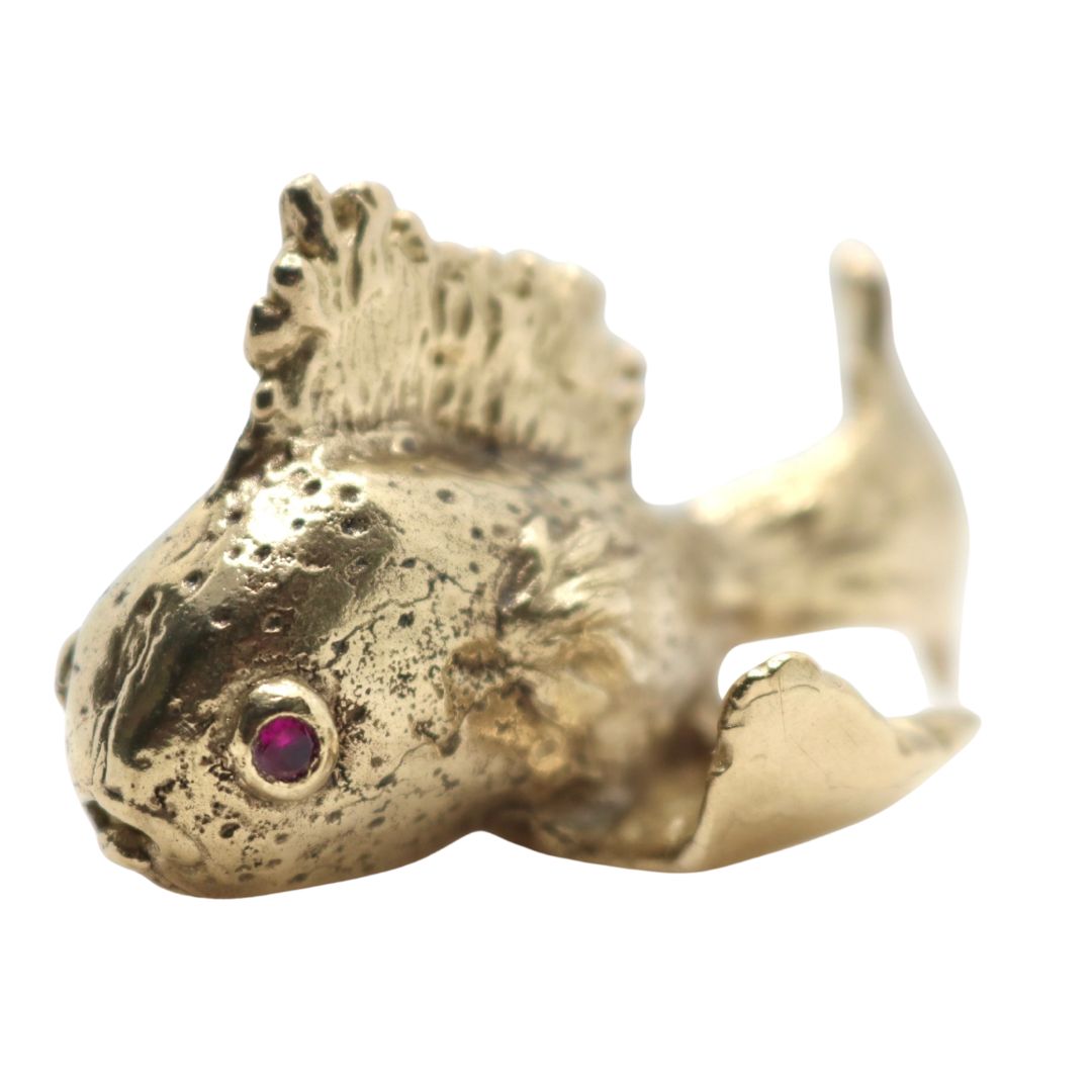Bronze Gold fish with a red gemstone eyes on a white background