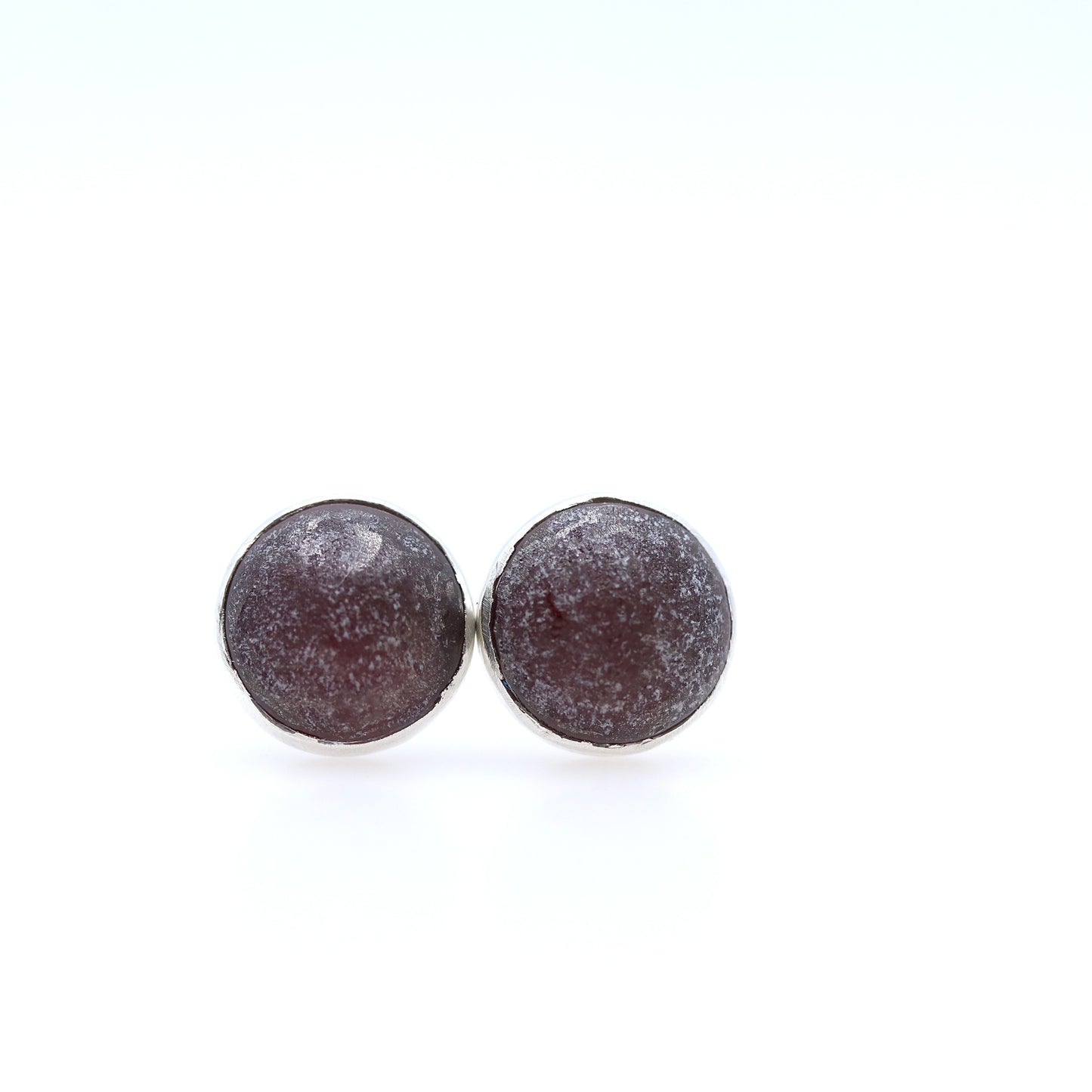 Round brown earrings on a white background