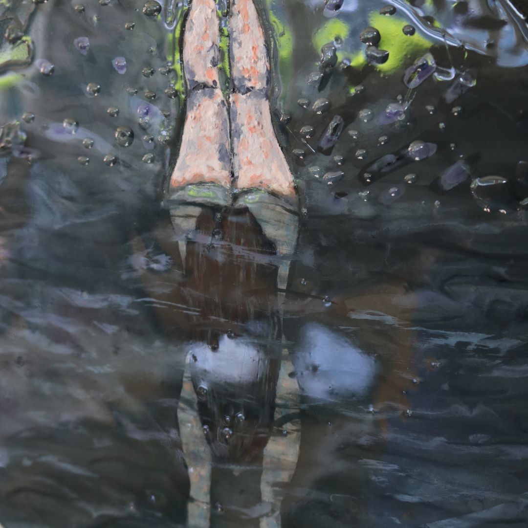 Close up detail of painting of woman diving below water with legs in the air