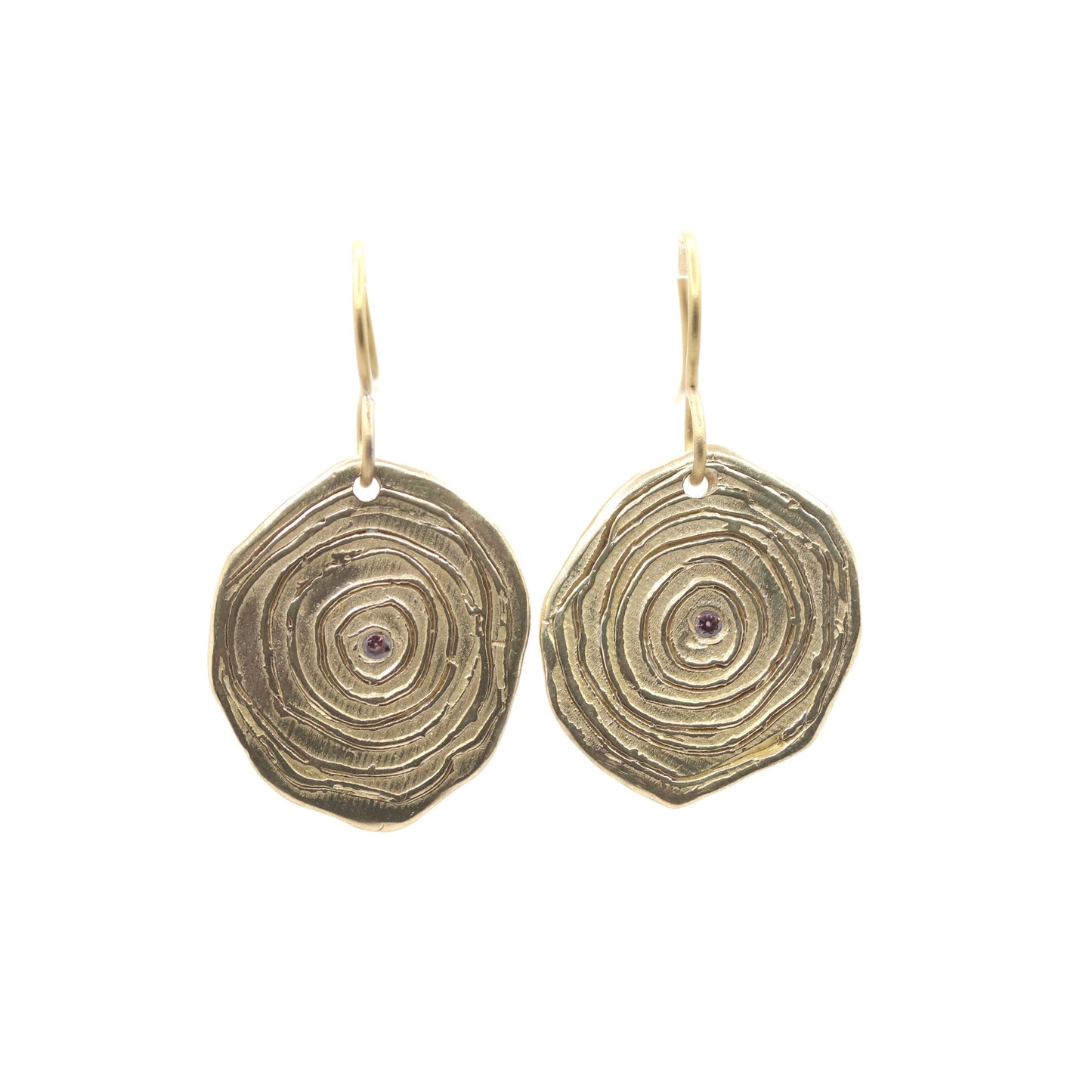 Pair of gold circular earrings with a white background