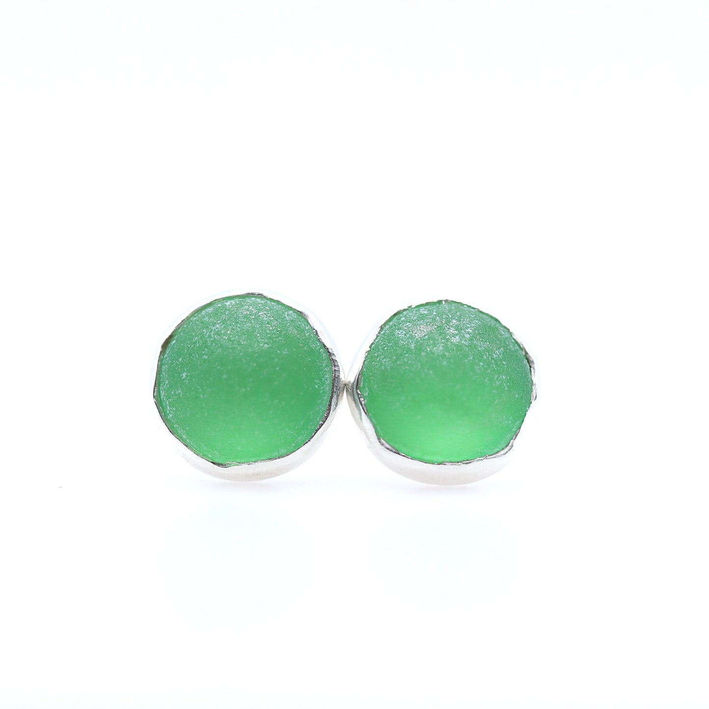 Green round earrings on a white background