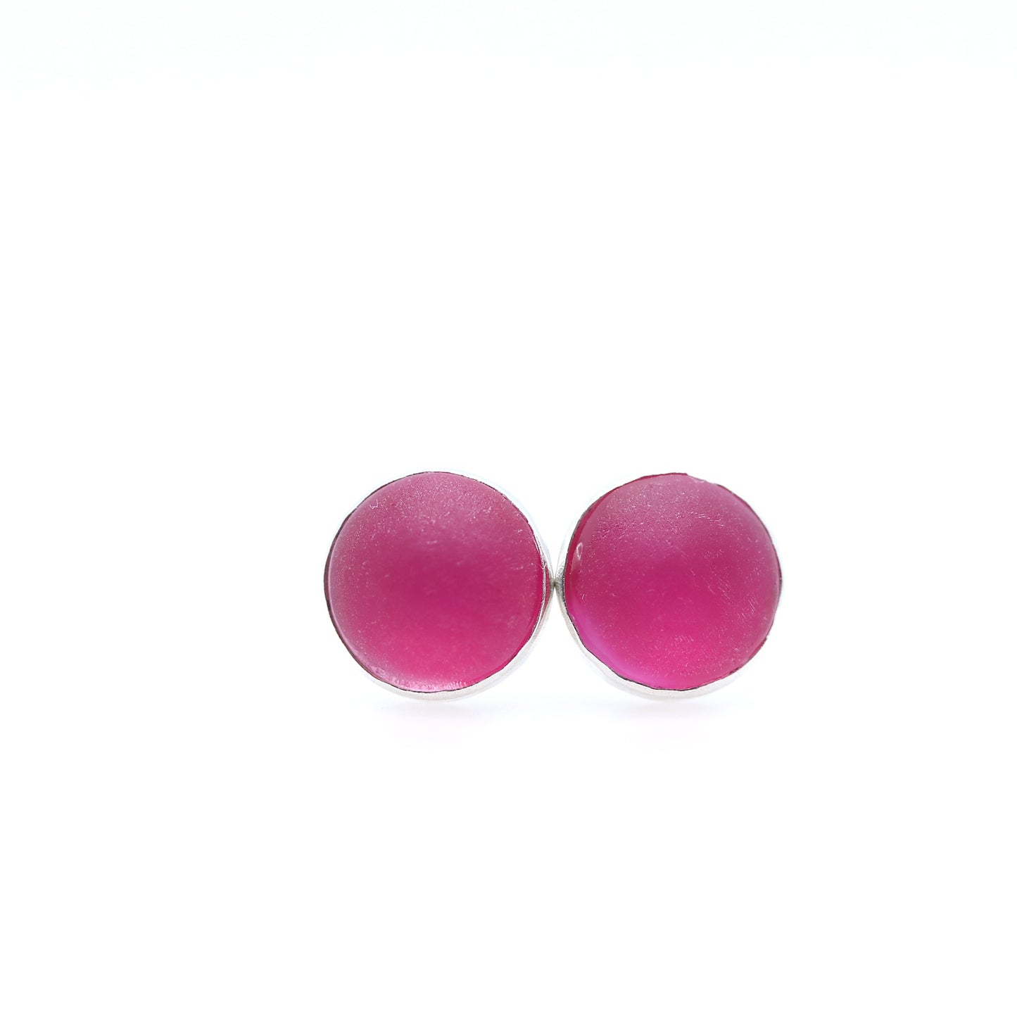 Pink earrings on a white background