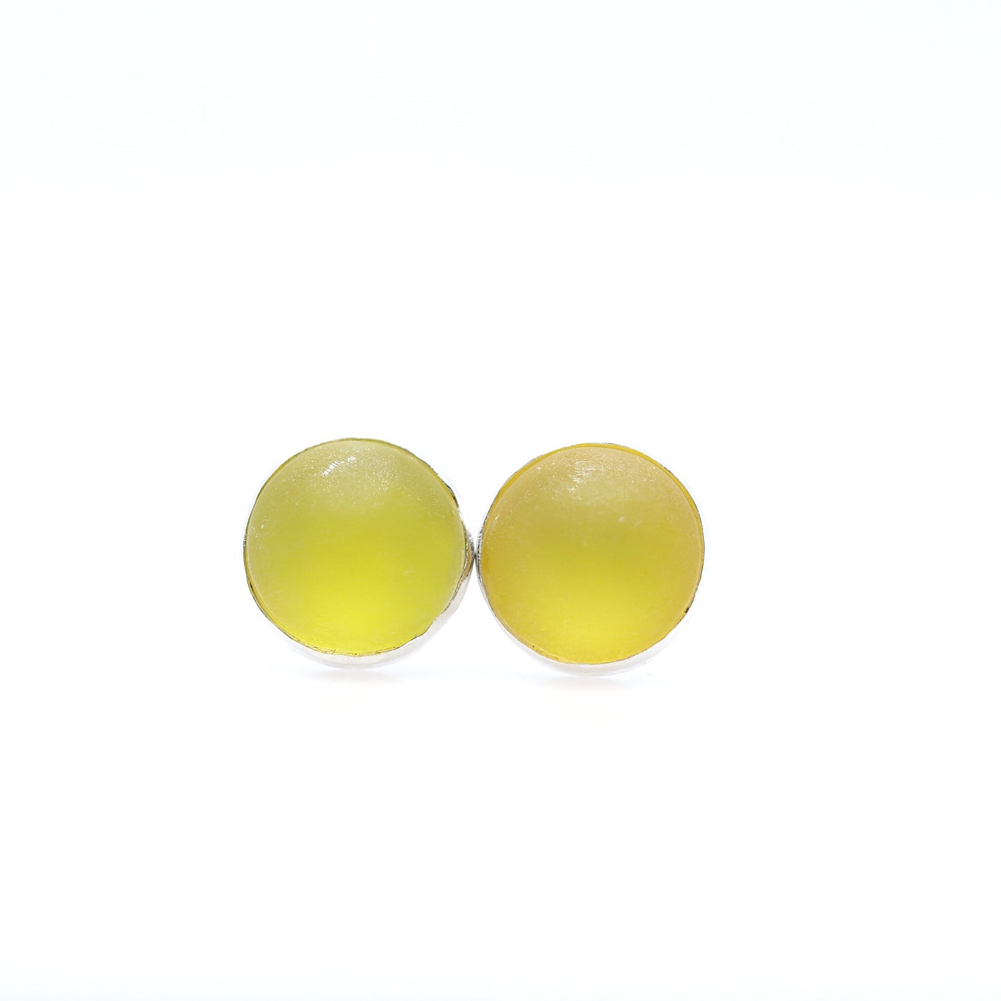 Pair of yellow round earrings on a white background