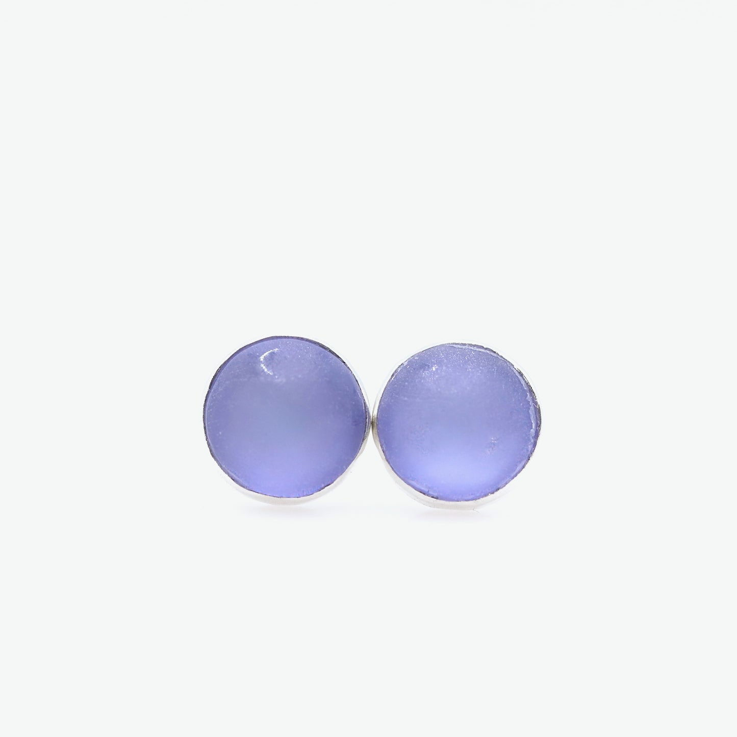 Pair of purple round earrings on a white background
