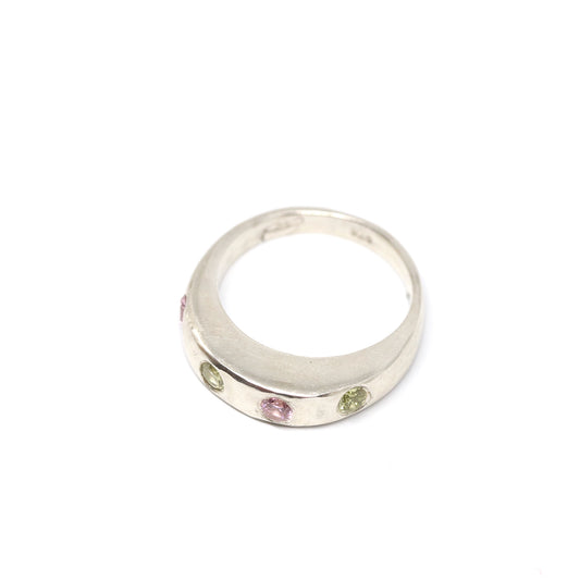 A silver ring with colourful gems. This ring was hand made in Wānaka, New Zealand by designer and jeweller Briar Hardy-Hesson.