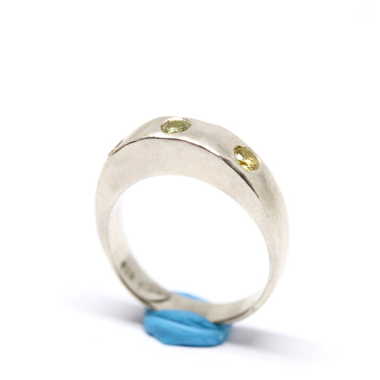 A silver ring with colourful gems. This ring was hand made in Wānaka, New Zealand by designer and jeweller Briar Hardy-Hesson.
