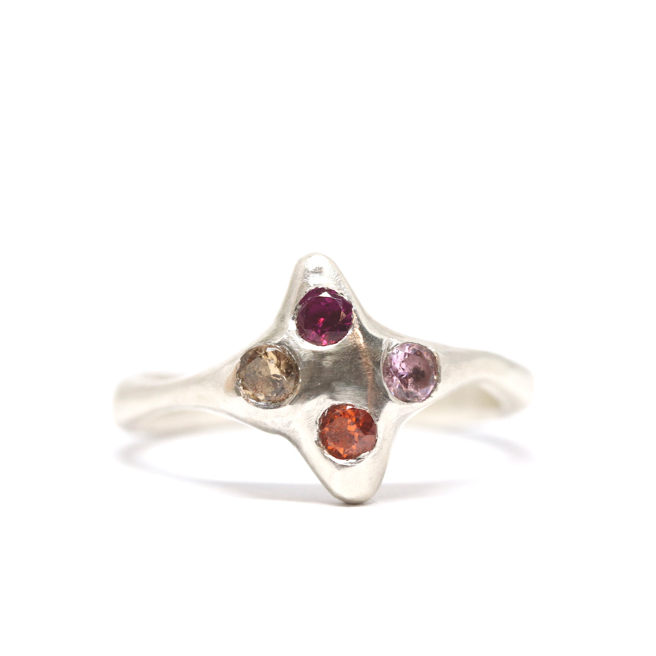 A silver ring with colourful gems. This ring was hand made in Wānaka, New Zealand by designer and jeweller Briar Hardy-Hesson.