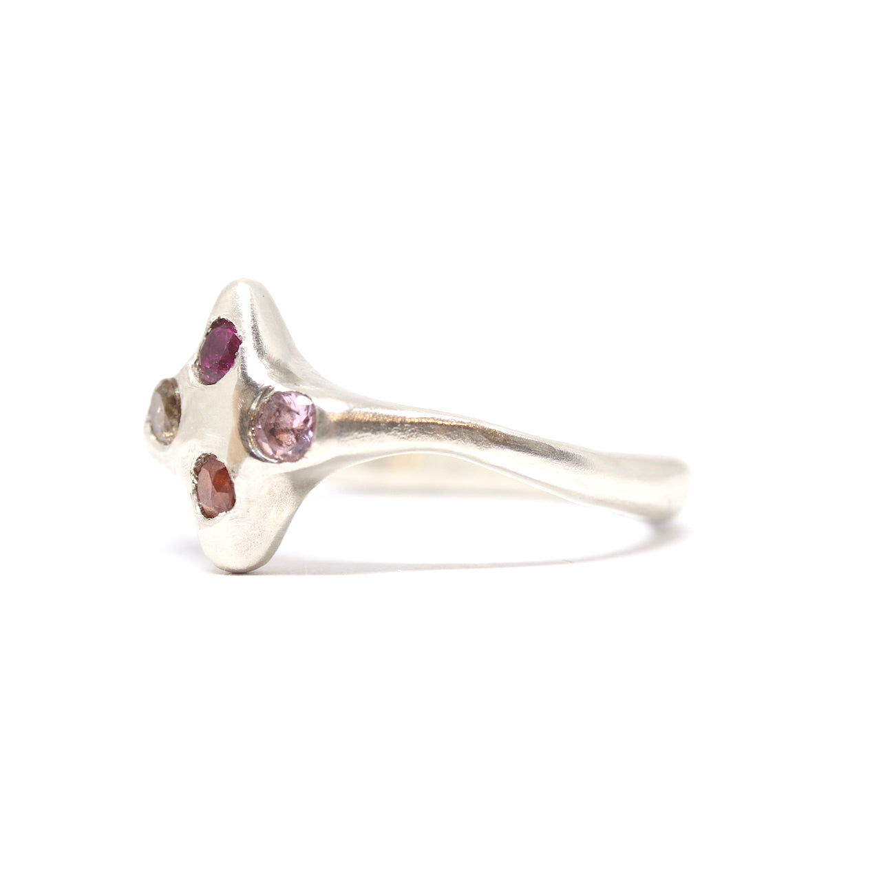 A silver ring with colourful gems. This ring was hand made in Wānaka, New Zealand by designer and jeweller Briar Hardy-Hesson.