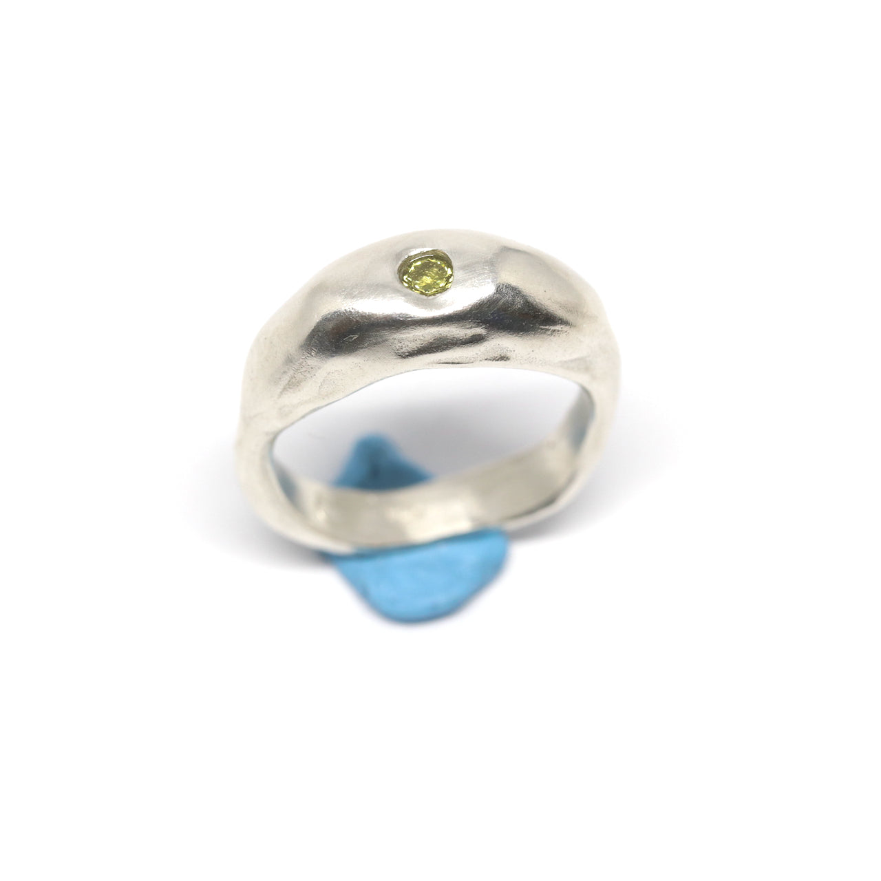 A silver ring with colourful gems. This ring was hand made in Wānaka, New Zealand by designer and jeweller Briar Hardy-Hesson.