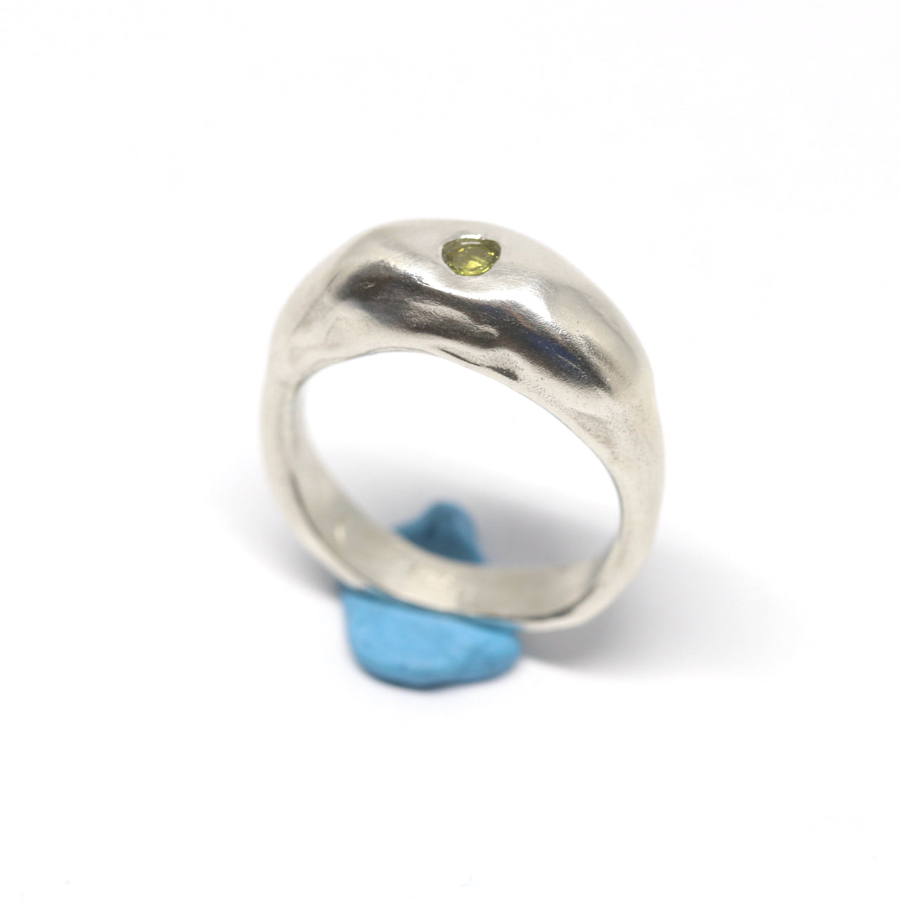 A silver ring with colourful gems. This ring was hand made in Wānaka, New Zealand by designer and jeweller Briar Hardy-Hesson.