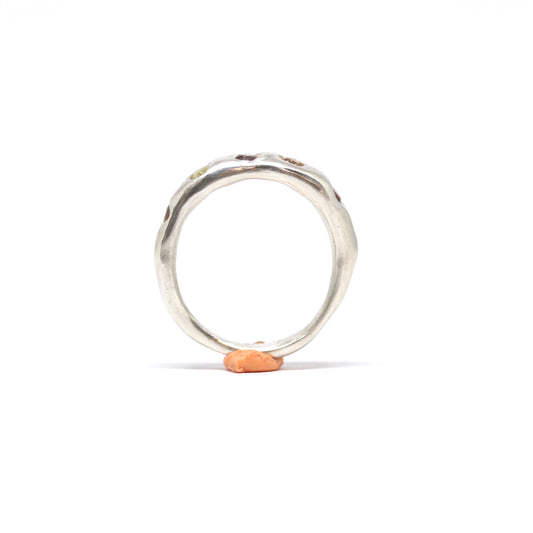A sterling silver ring with five cubic zirconia in autumnal shades