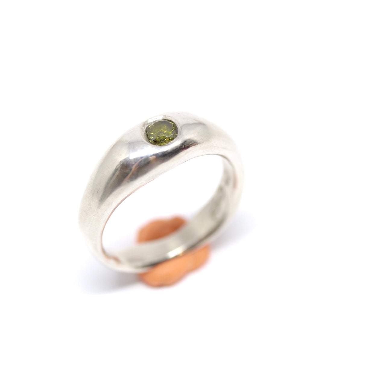 A sterling silver ring with one olive gem.