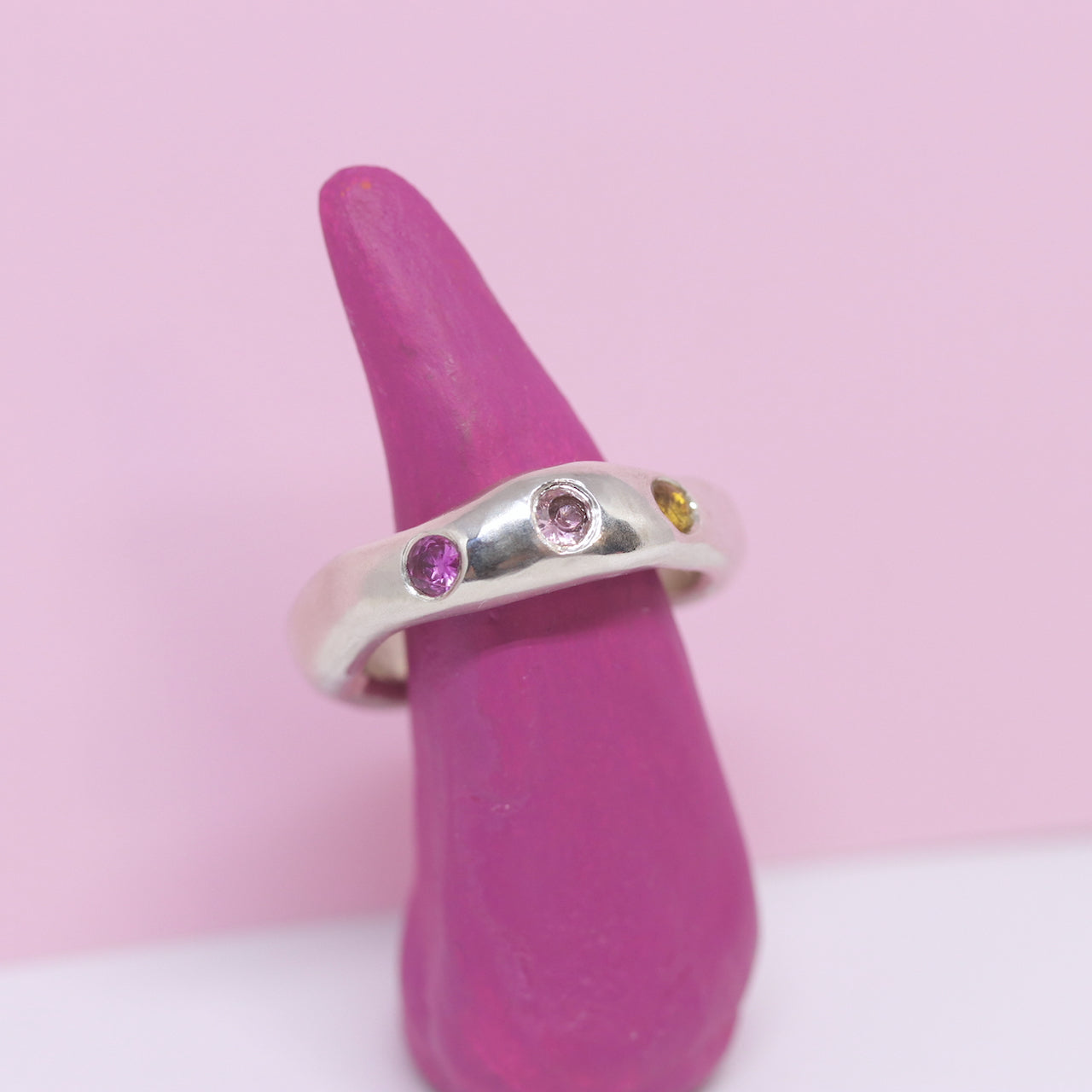 A sterling silver ring, just a tad chunky with citrine, pink and ruby pink cubic zirconia.