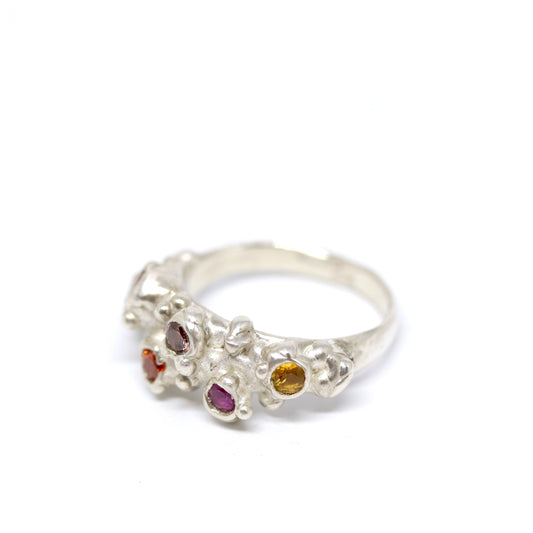 A big, bold sterling silver ring with 6 cubic zirconia in autumnal shades of pink and orange.