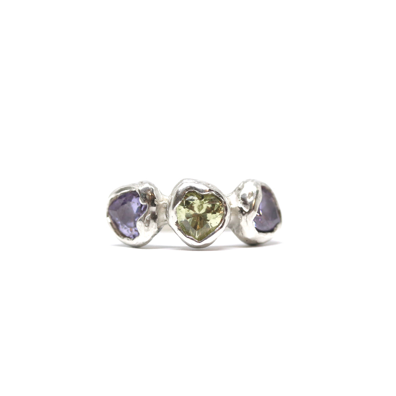 Three heart shaped cubic zirconia in lavender and light green. Encased in melty sterling silver. Hand made in Wānaka, New Zealand by designer and jeweller Briar Hardy-Hesson.