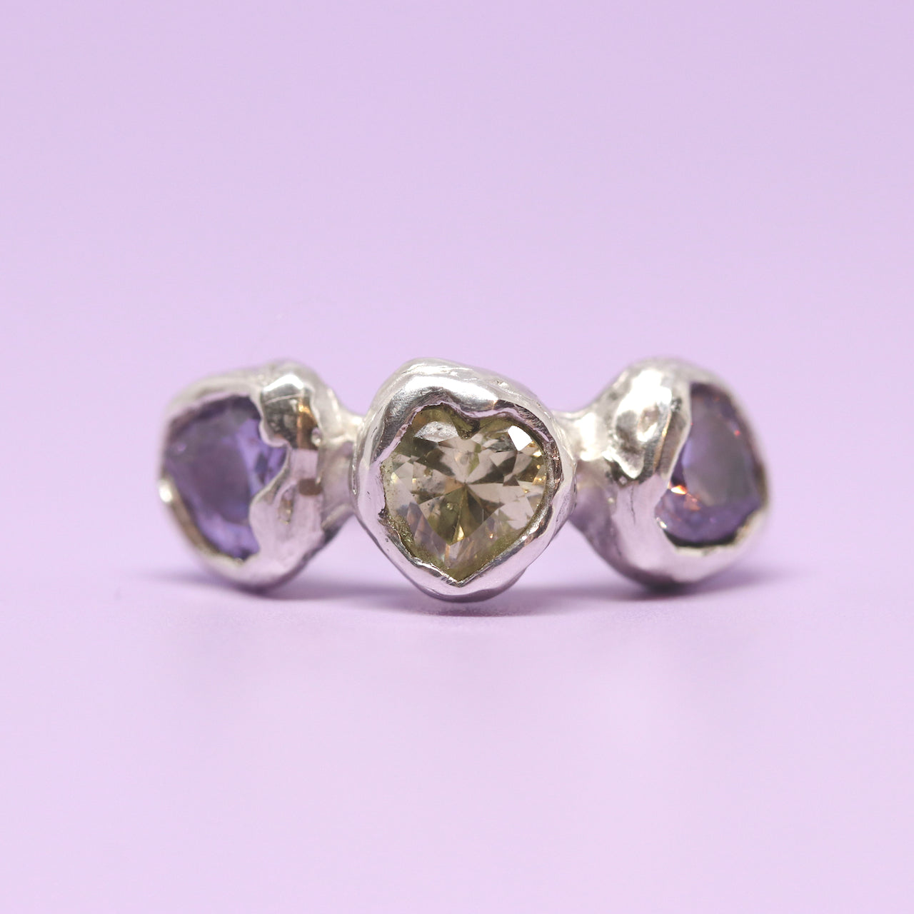 Three heart shaped cubic zirconia in lavender and light green. Encased in melty sterling silver. Hand made in Wānaka, New Zealand by designer and jeweller Briar Hardy-Hesson.