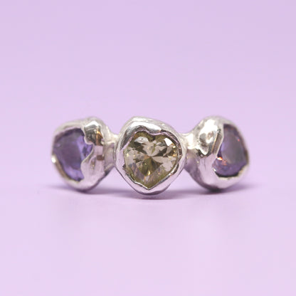 Three heart shaped cubic zirconia in lavender and light green. Encased in melty sterling silver. Hand made in Wānaka, New Zealand by designer and jeweller Briar Hardy-Hesson.