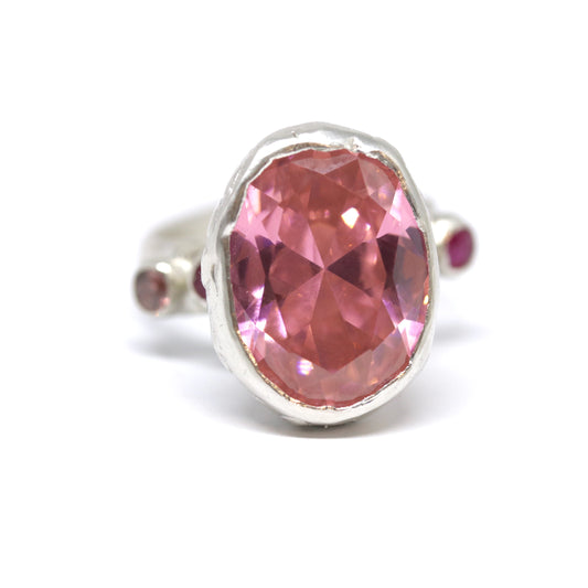 A really big pink cubic zirconia cocktail, statement ring with two ruby pink and two rhodolite cubic zirconia on the shoulders.
