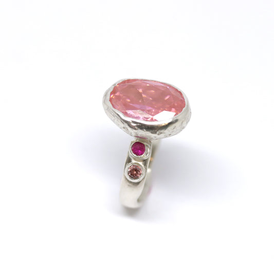 A really big pink cubic zirconia cocktail, statement ring with two ruby pink and two rhodolite cubic zirconia on the shoulders.