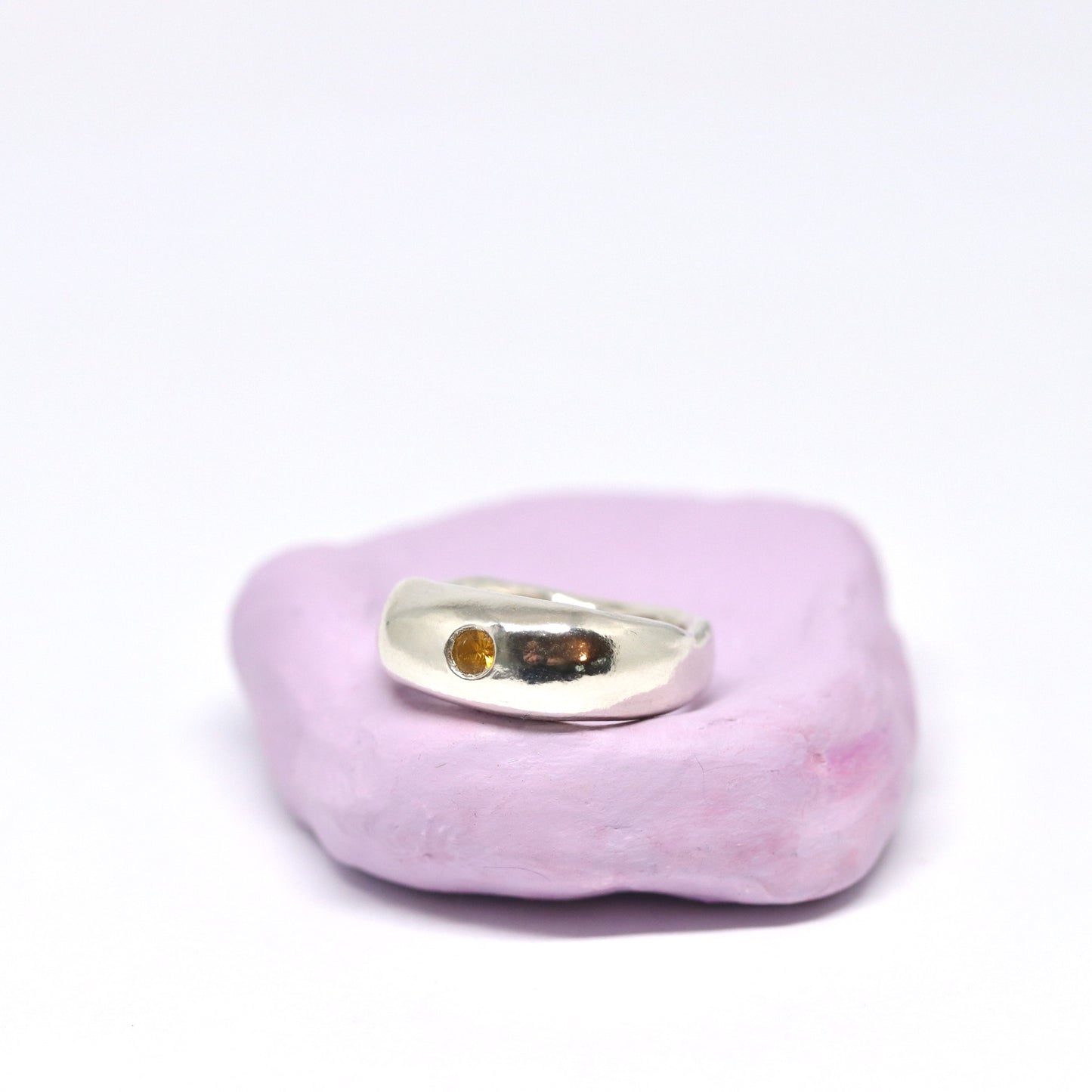 A curvy and chunky sterling silver ring with one citrine gem.