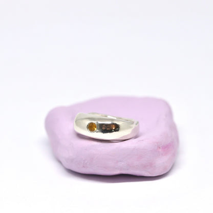 A curvy and chunky sterling silver ring with one citrine gem.