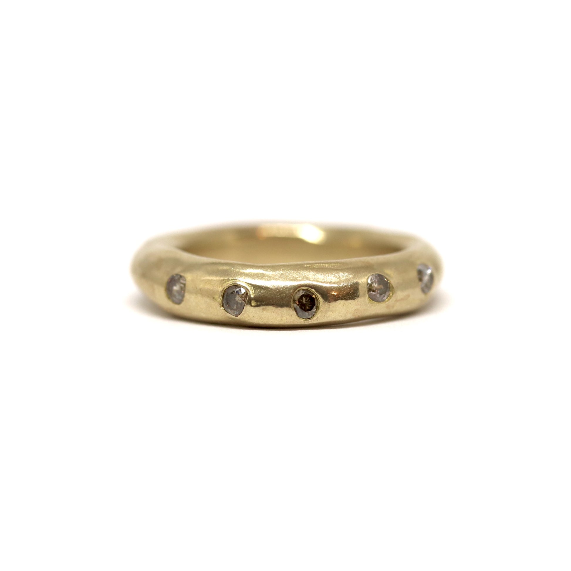 Bronze ring with smoky grey gemstones on a white background