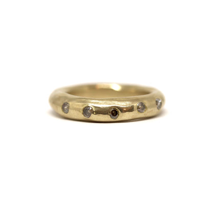 Bronze ring with smoky grey gemstones on a white background