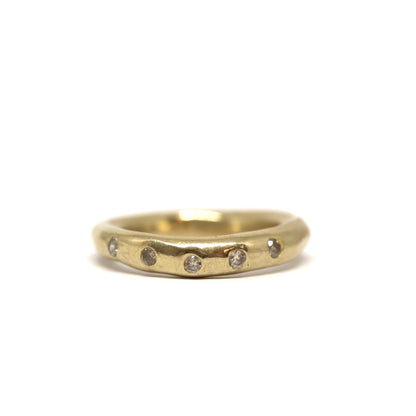 Bronze ring with smoky grey gemstones on a white background