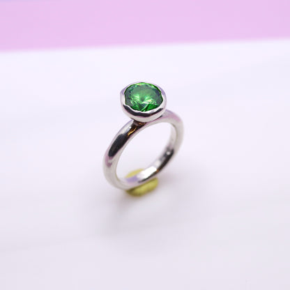 Silver ring with a tsavorite green gemstone on a white background. New Zealand made jewellery designer