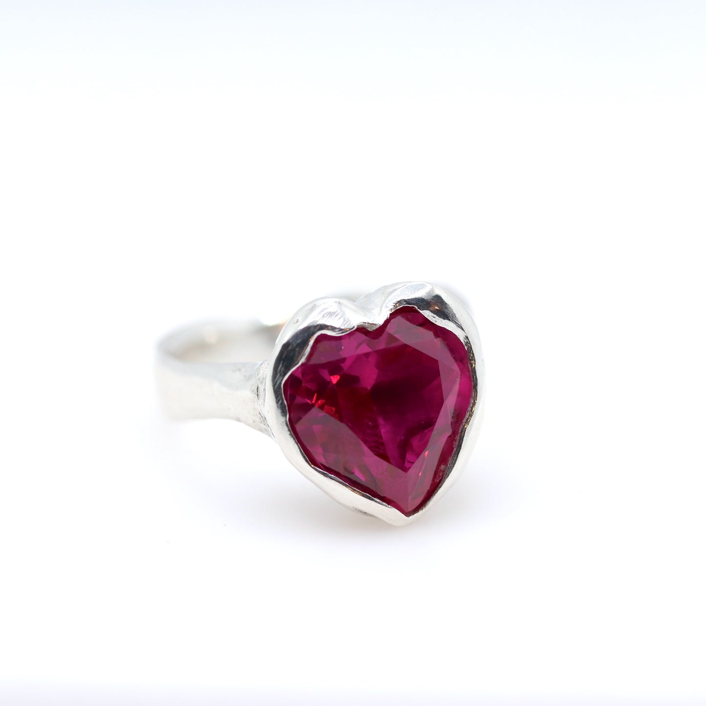 Silver ring with a pink heart-shaped gemstone on a white background. New Zealand made jewellery designer