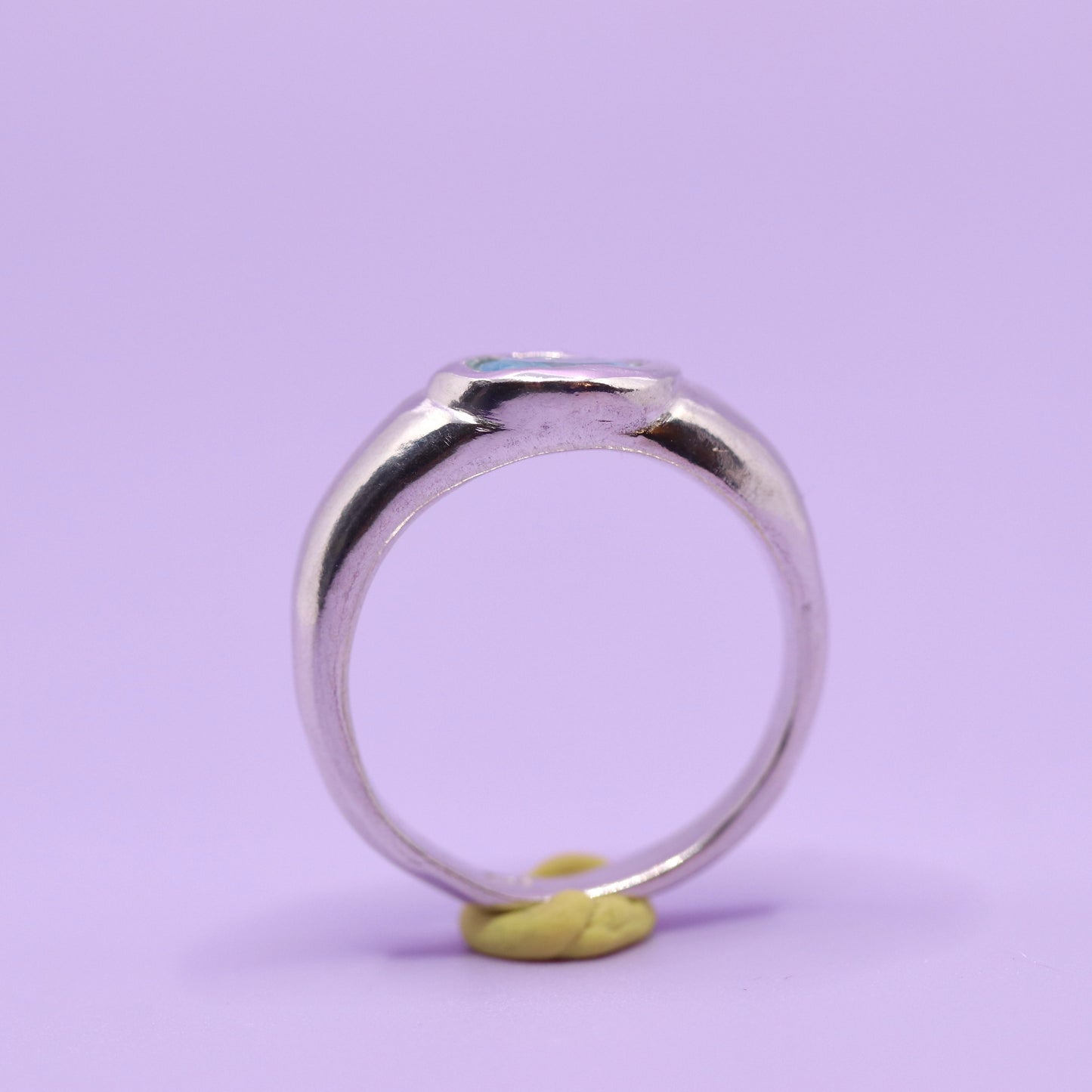 Silver ring with a blue stone on a purple background. New Zealand made jewellery designer