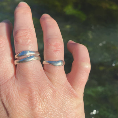 Waterworn silver rings worn by a Wānaka creek