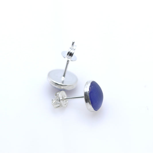 Pair of silver stud earrings with blue domes on a white background